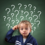 Child thinking with question mark on blackboard